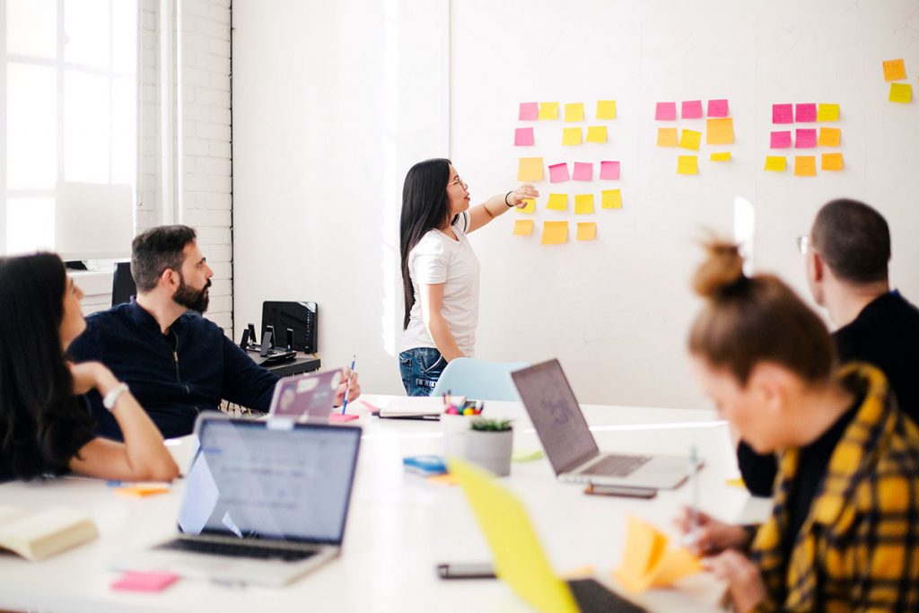 A team of people is fully relaxed after corporate massages and getting down to work.